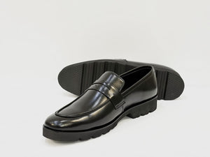 Black loafers on a white background