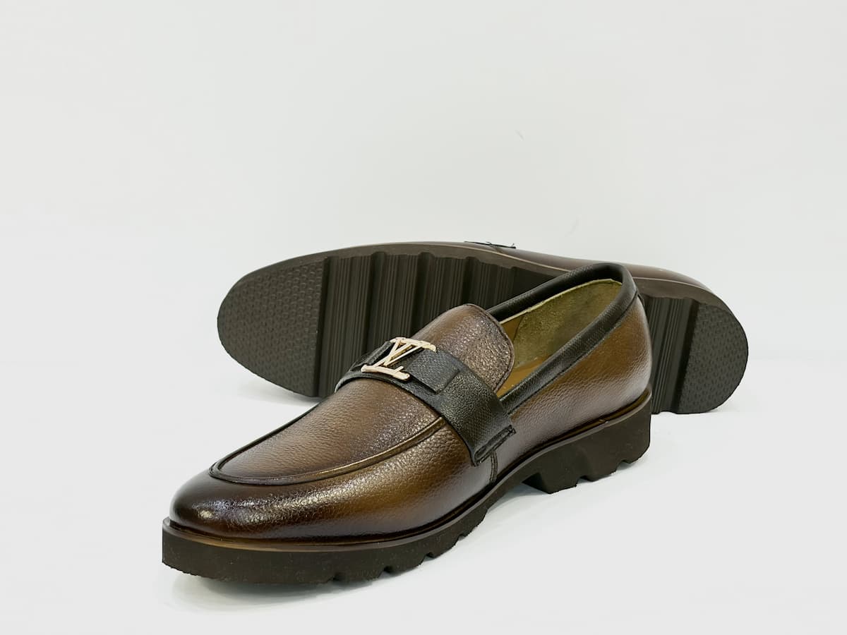 Brown leather loafer shoe on a white background